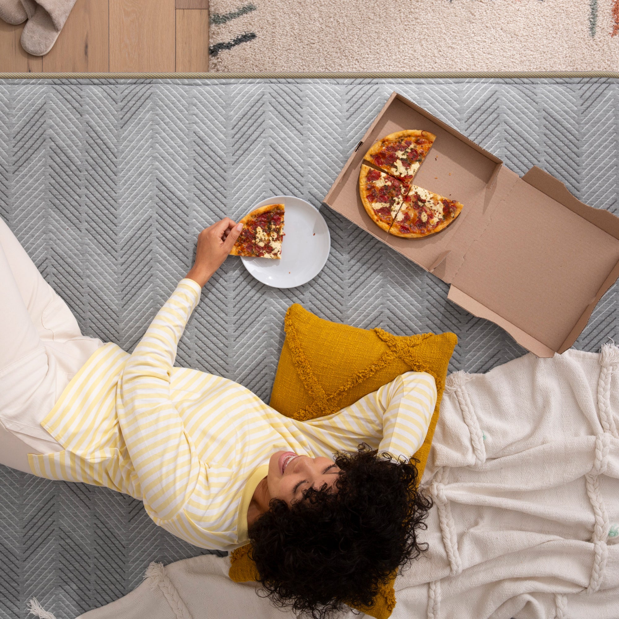 Woman eating pizza on Hybrid Firm Mattress