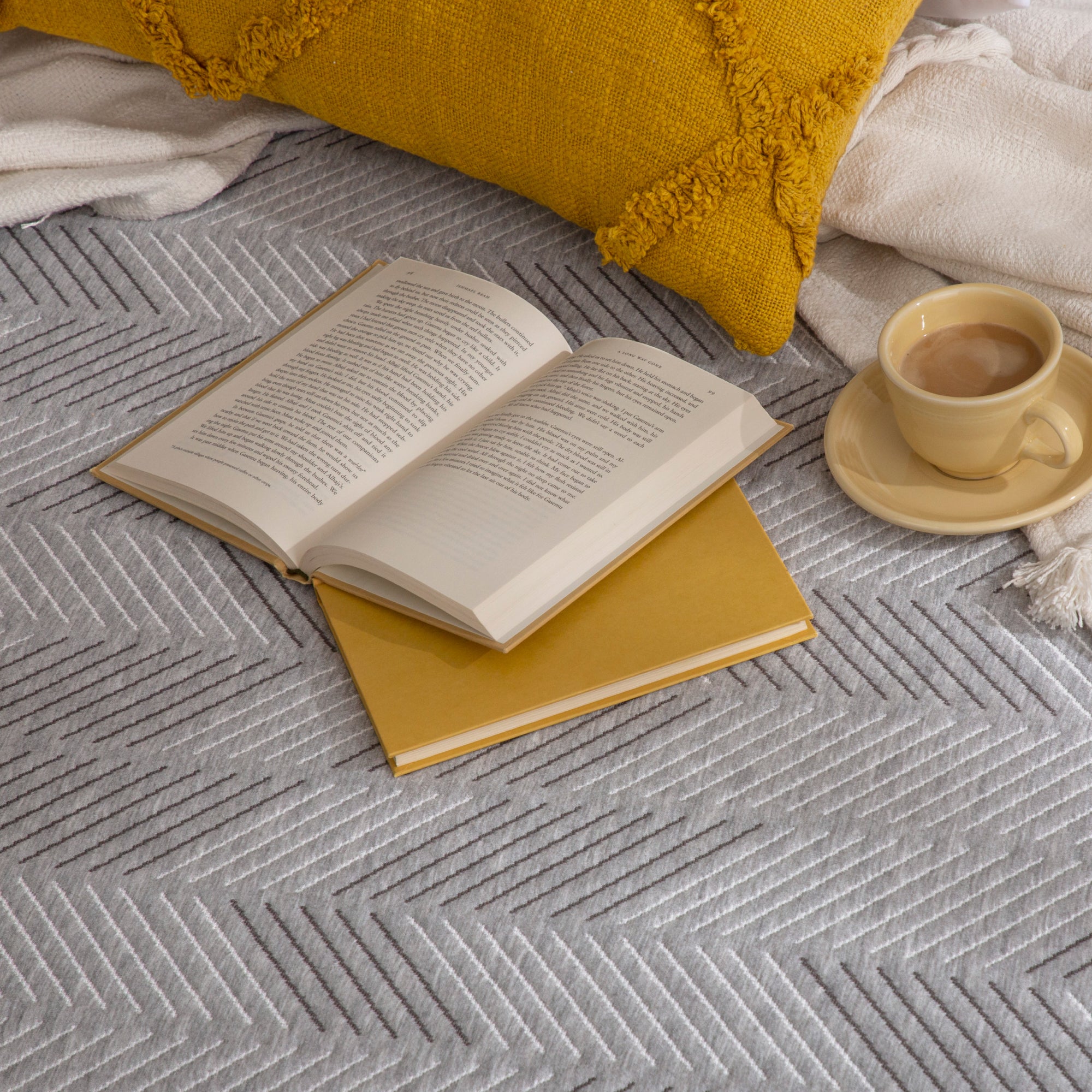 Book and a cup of coffee on Hybrid Plush Mattress