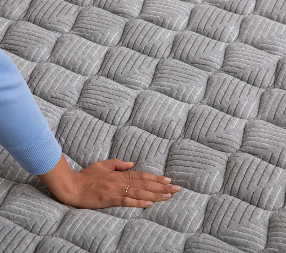 Hand pressing down on Quilted Firm Mattress
