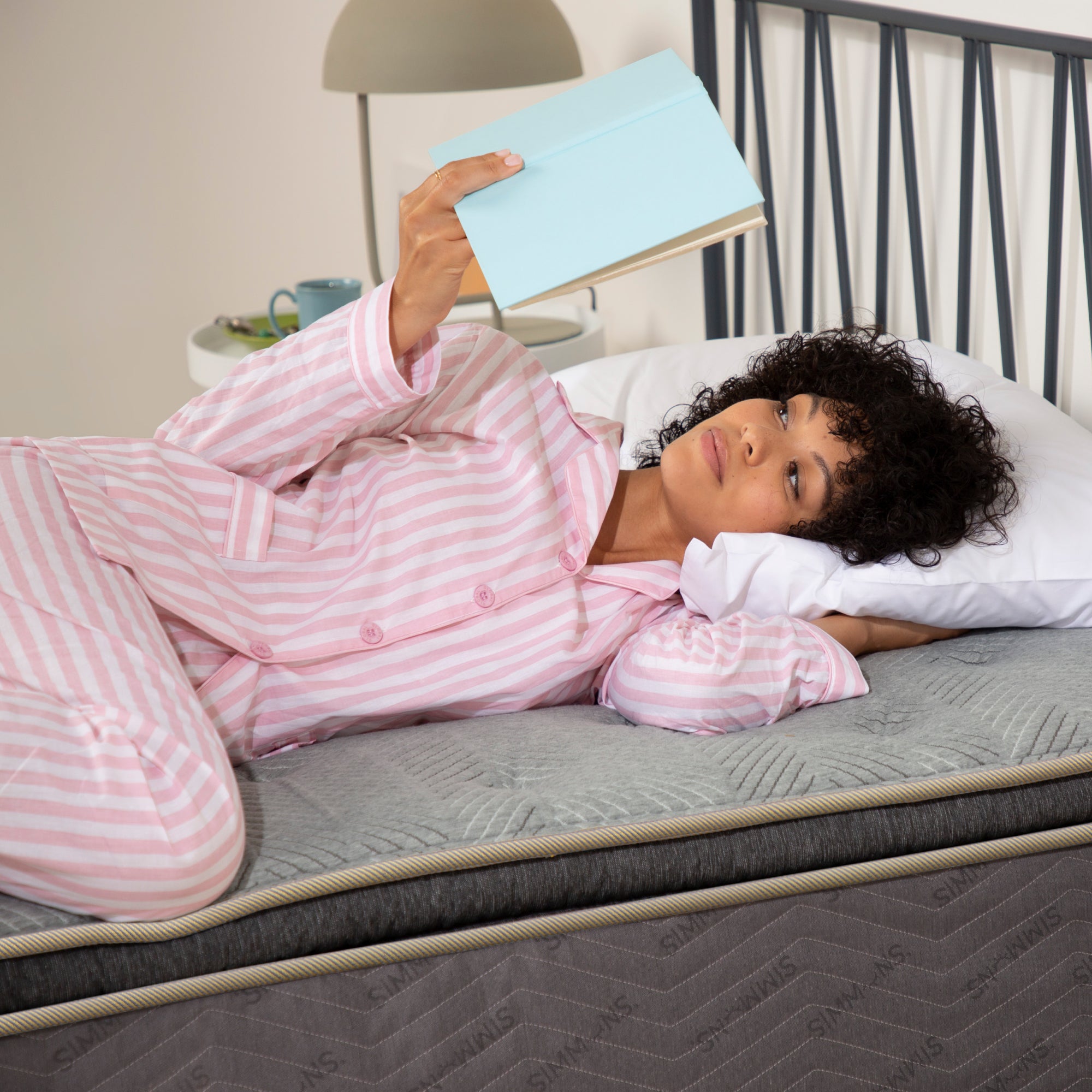 Woman reading a book on Quilted Medium Pillow Top Mattress