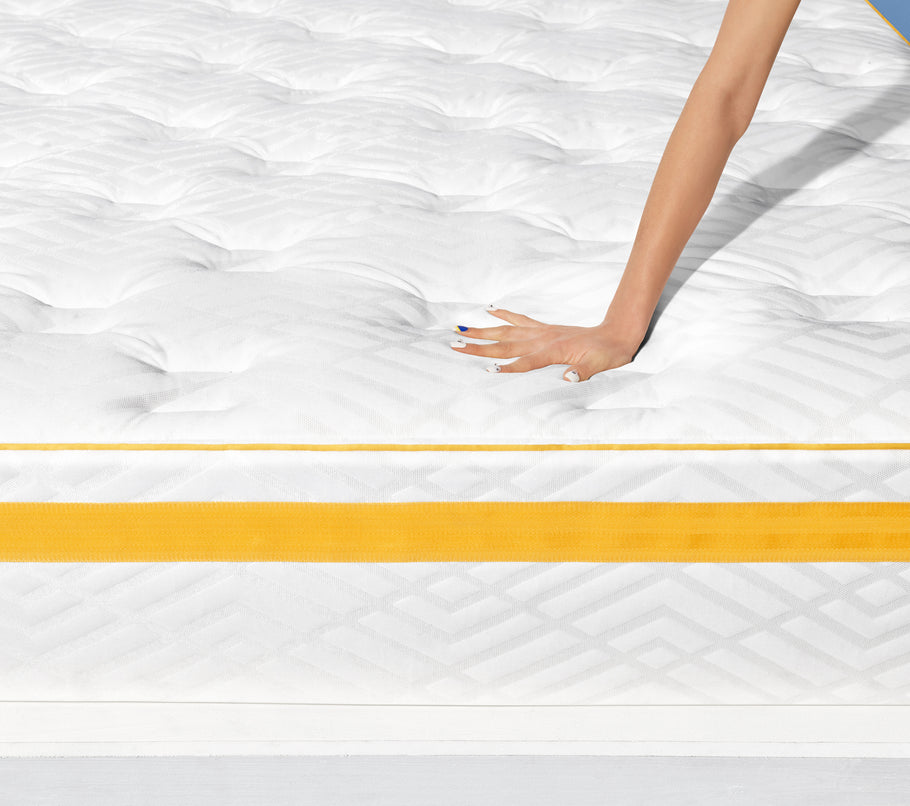 Hand pressing down on Hybrid - Plush Support mattress